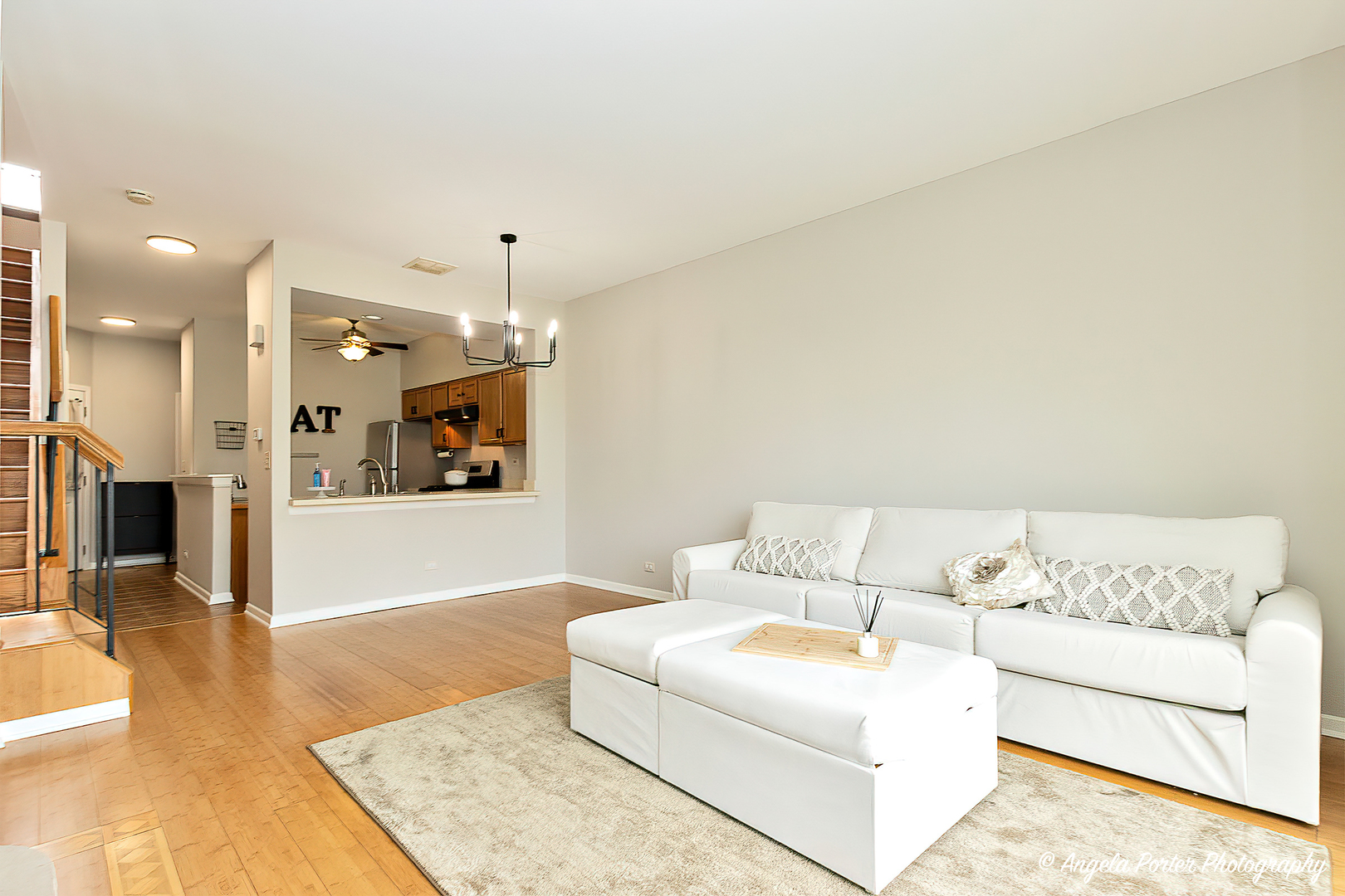 17838 Braewick Road, Unit 16017 Gurnee, IL 60031 - Photo 4 of 28 a living room with furniture and a chandelier