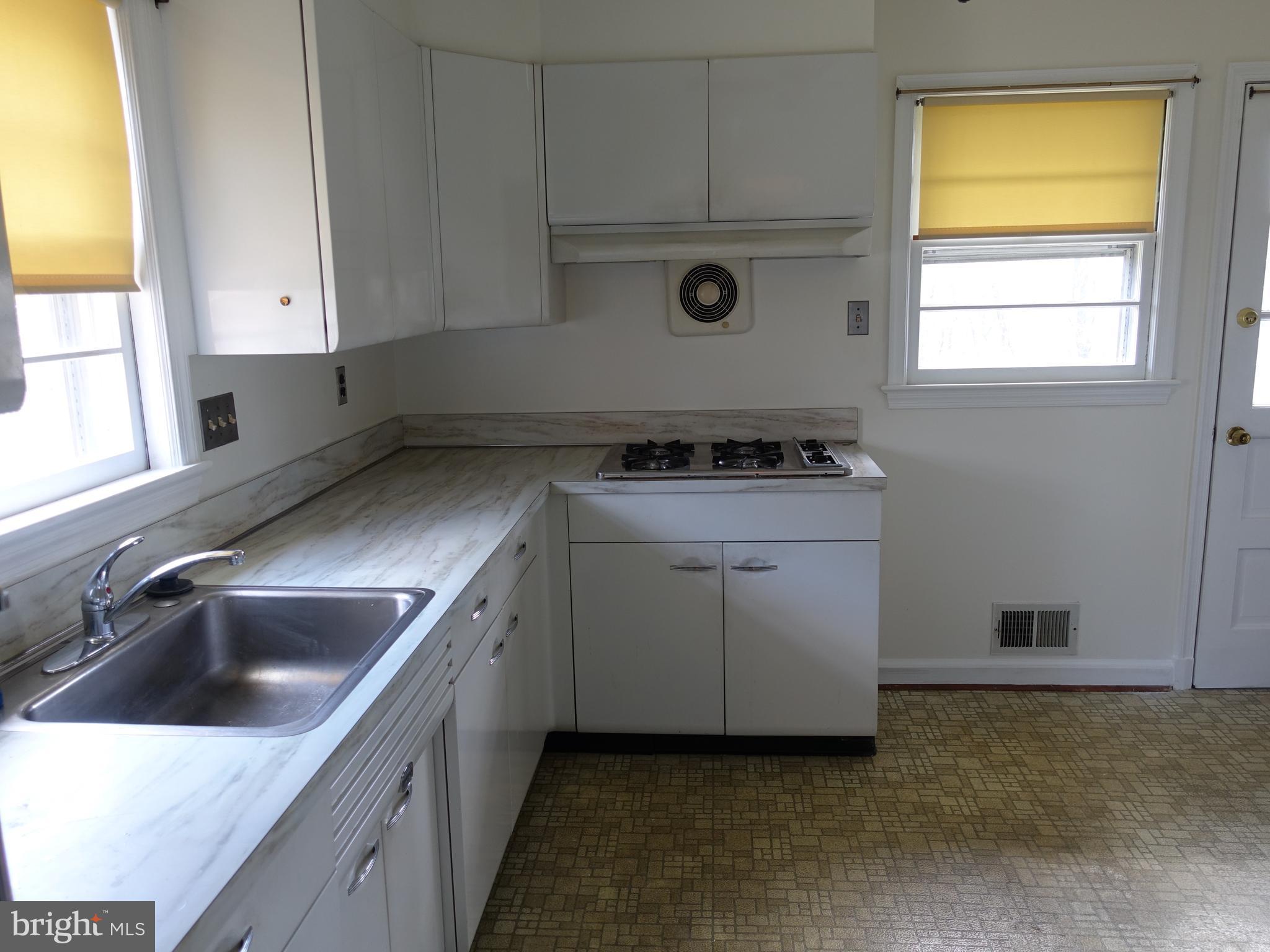 2619 Higbee Road Adelphi, MD 20783 - Photo 5 of 12 a kitchen with a stove and a sink