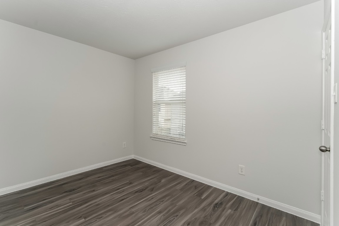 2410 High Island Way Houston, TX 77073 - Photo 15 of 17 a view of an empty room with wooden floor and a window
