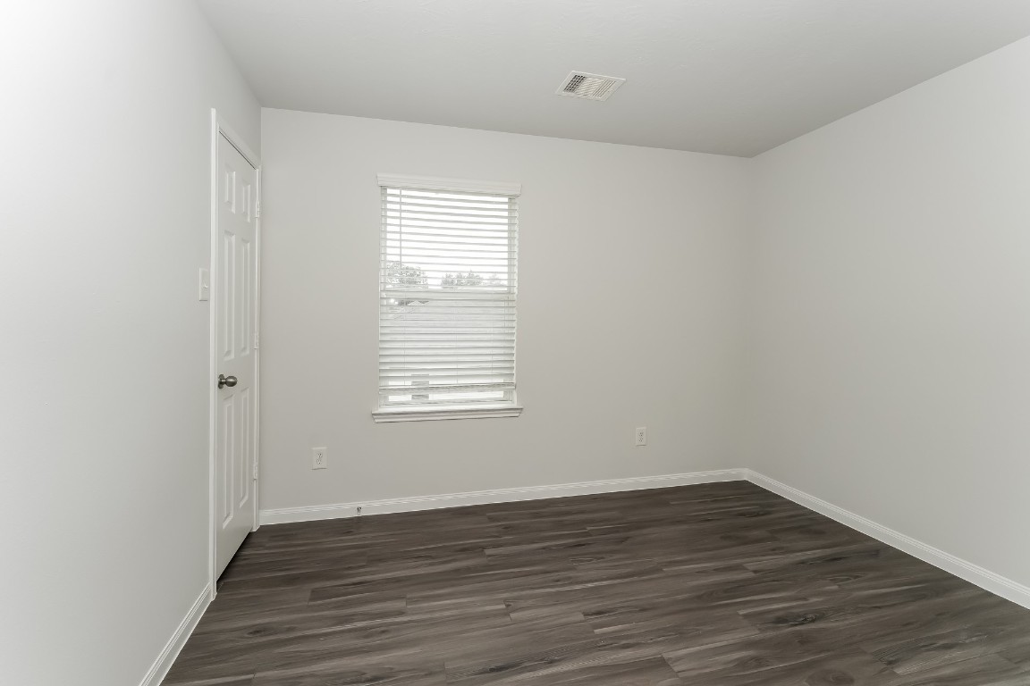 2410 High Island Way Houston, TX 77073 - Photo 16 of 17 a view of an empty room with wooden floor and a window