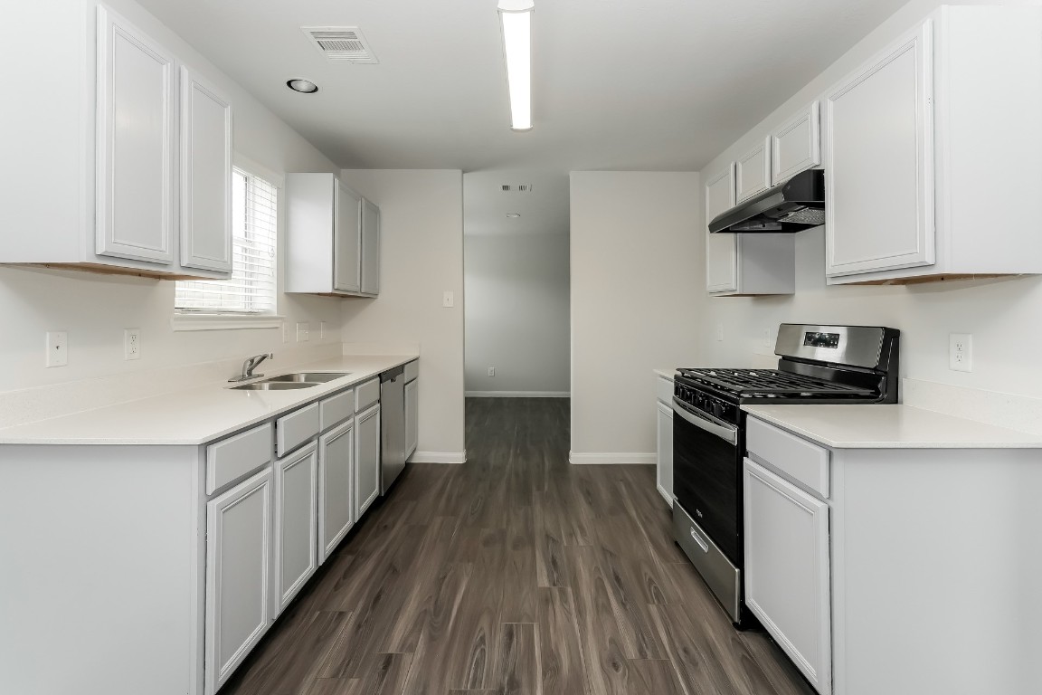 2410 High Island Way Houston, TX 77073 - Photo 4 of 17 a kitchen with cabinets a sink and appliances