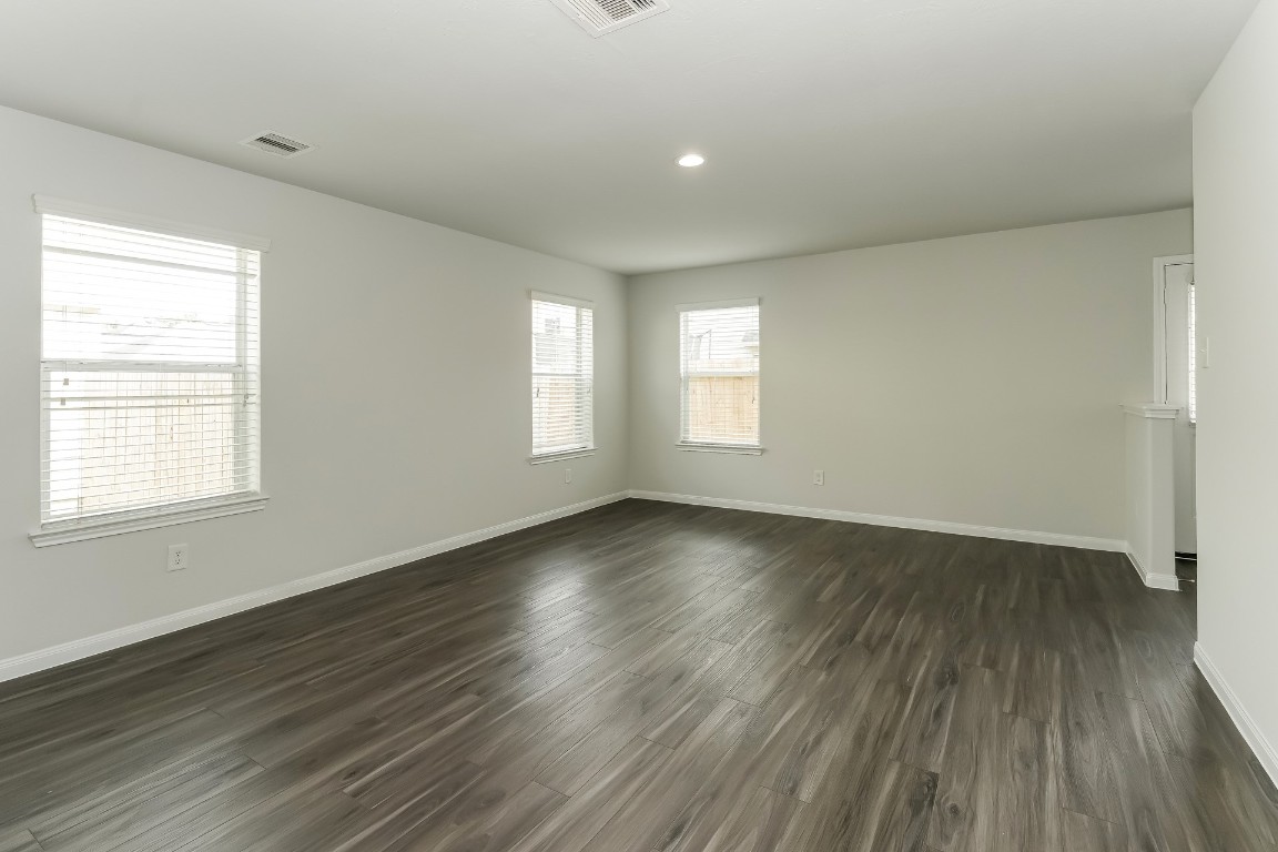 2410 High Island Way Houston, TX 77073 - Photo 7 of 17 an empty room with wooden floor and windows