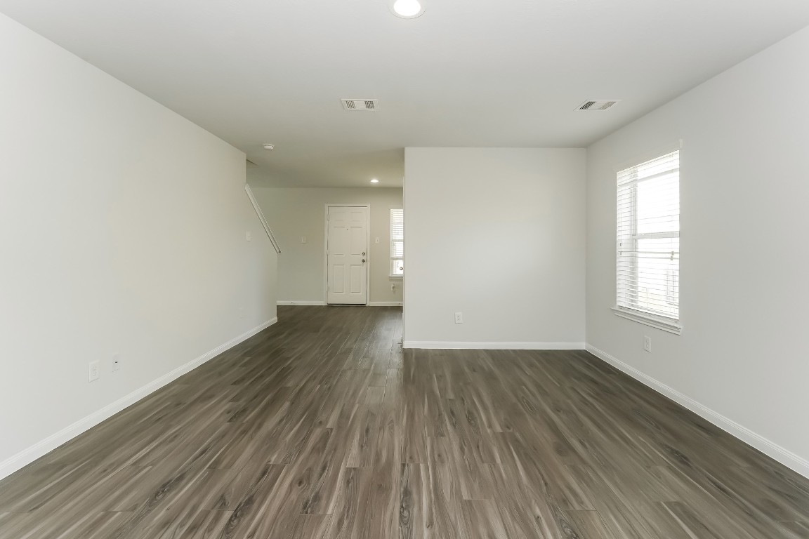 2410 High Island Way Houston, TX 77073 - Photo 9 of 17 an empty room with wooden floor and windows