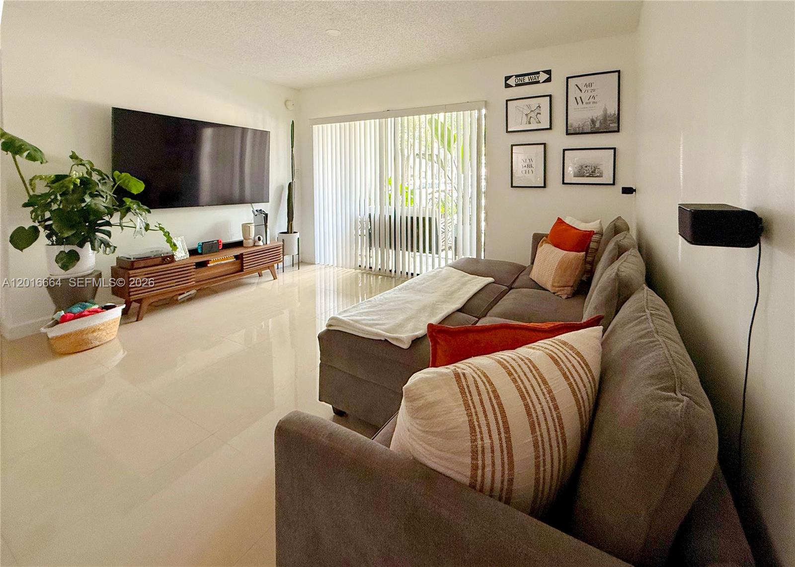 530 South Park Road, Unit 1211 Hollywood, FL 33021 - Photo 2 of 5 a living room with furniture and a flat screen tv