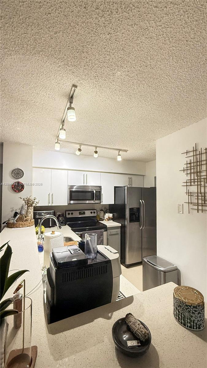 530 South Park Road, Unit 1211 Hollywood, FL 33021 - Photo 3 of 5 a kitchen with a sink and stove top oven
