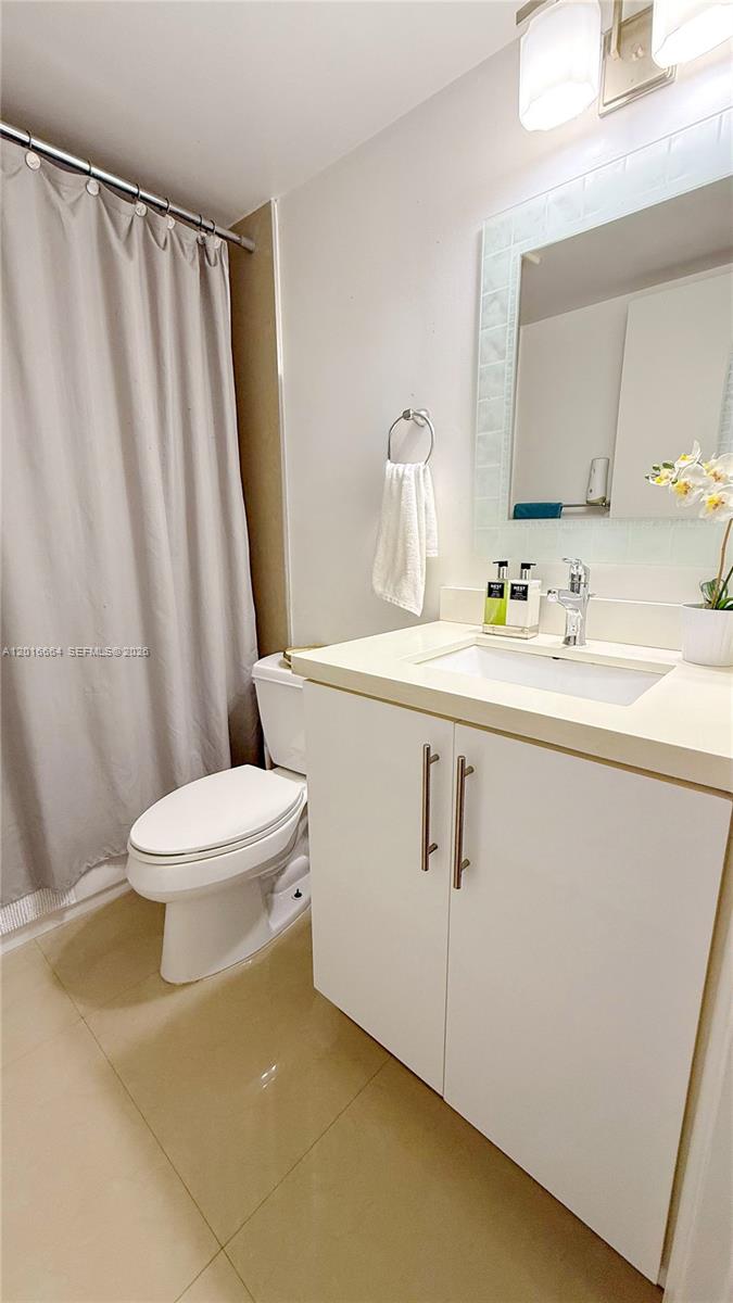 530 South Park Road, Unit 1211 Hollywood, FL 33021 - Photo 5 of 5 a white toilet sitting next to a bathroom sink