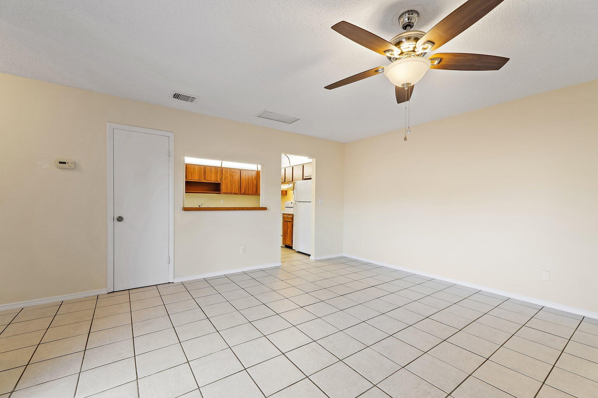 3581 Southeast Cobia Way Stuart, FL 34997 - Photo 12 of 26 a view of an empty room and chandelier fan