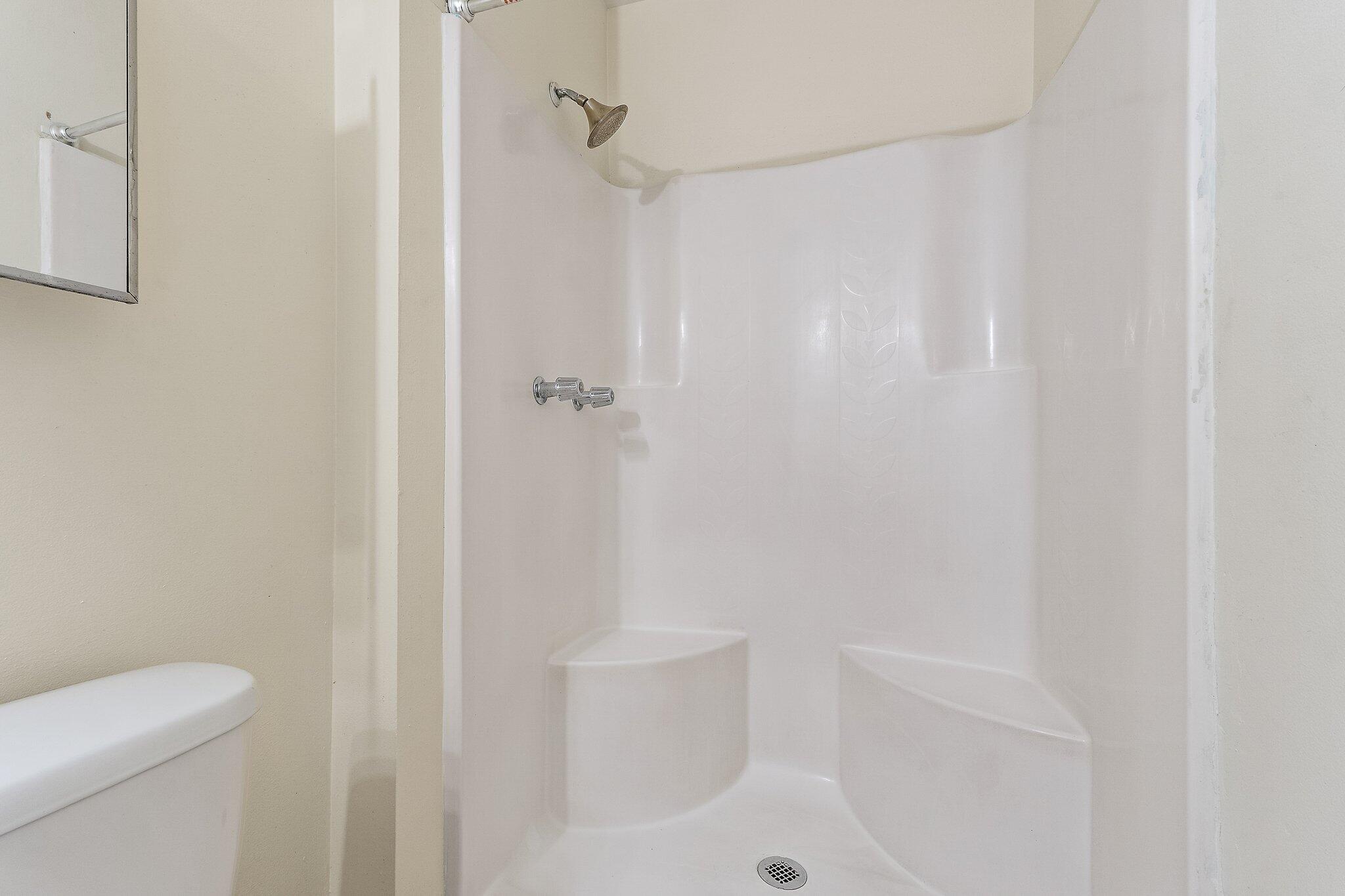 3581 Southeast Cobia Way Stuart, FL 34997 - Photo 21 of 26 a bathroom with a shower and toilet