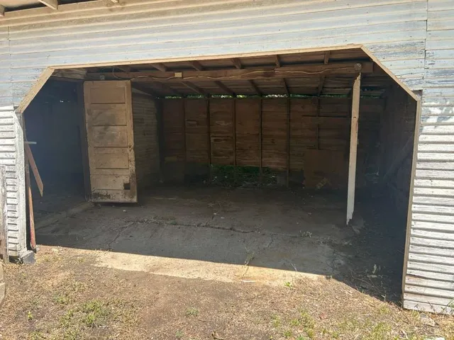 a backyard of a house with table and chairs