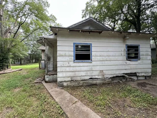 a view of a wooden house with a yard