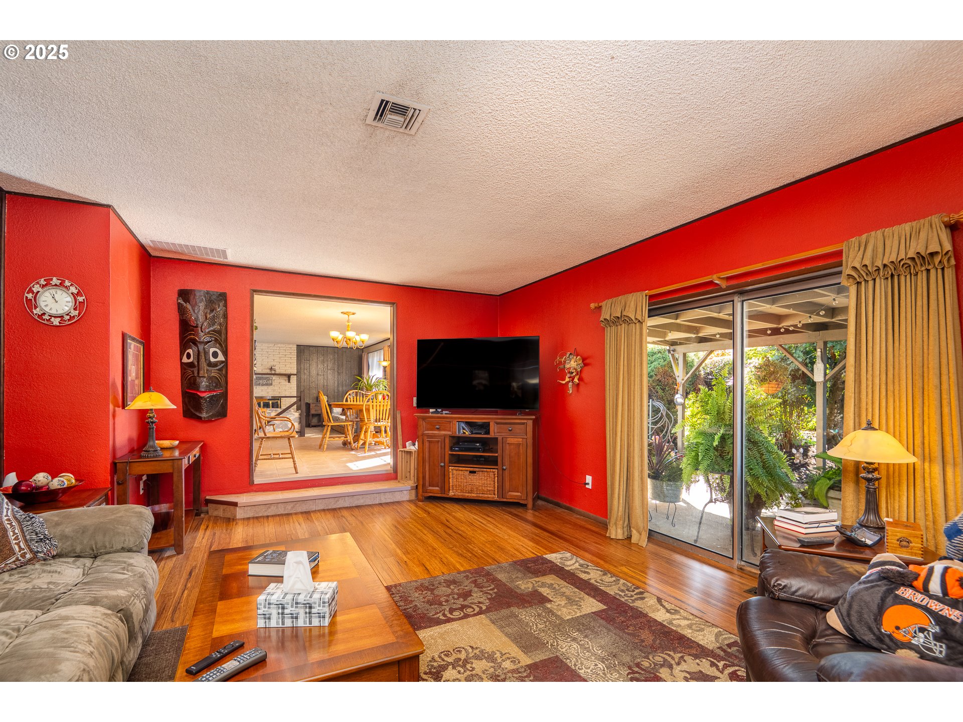 2121 Firth Avenue Springfield, OR 97477 - Photo 20 of 40 a living room with furniture a flat screen tv and floor to ceiling window
