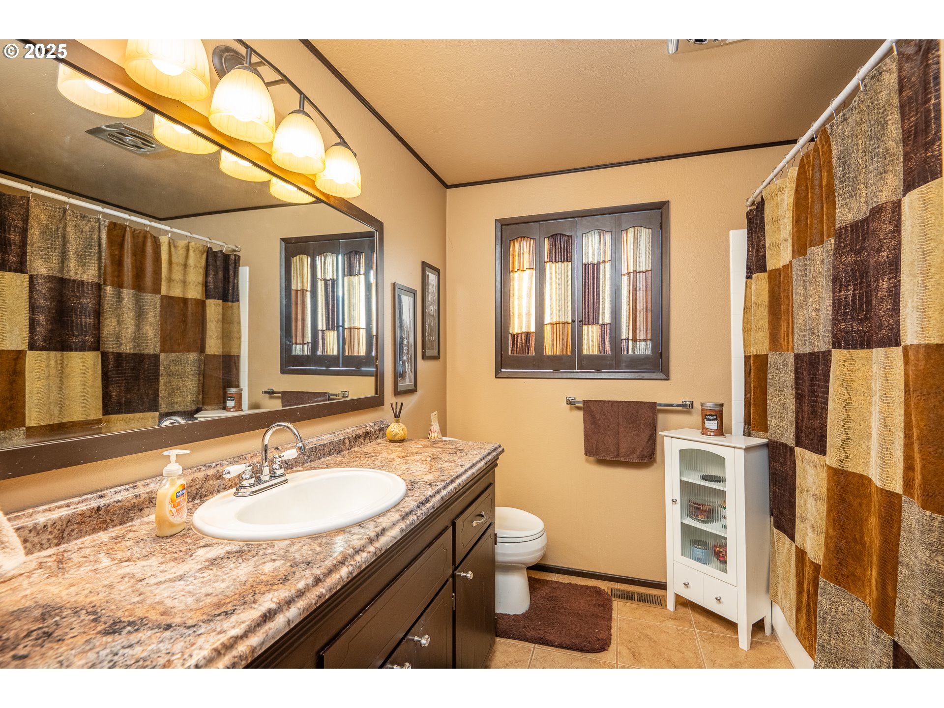 2121 Firth Avenue Springfield, OR 97477 - Photo 24 of 40 a bathroom with a granite countertop sink a mirror and a shower
