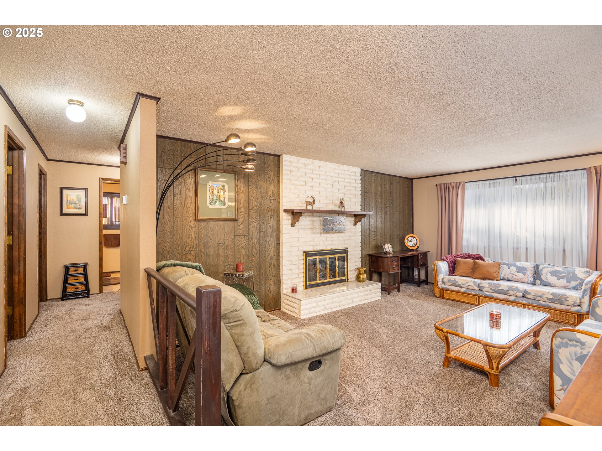 2121 Firth Avenue Springfield, OR 97477 - Photo 8 of 40 a living room with furniture a fireplace and gym equipment