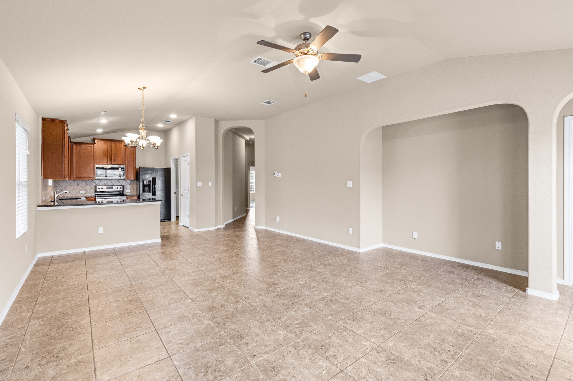 19308 Stokes Lane Pflugerville, TX 78660 - Photo 3 of 27 a view of an empty room and kitchen view