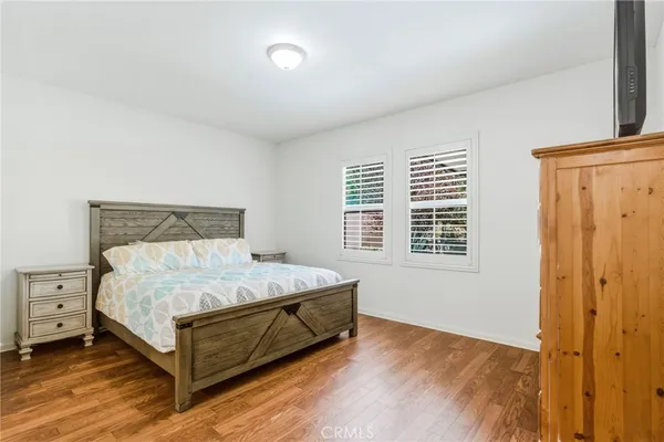 a bed sitting in a bedroom next to a window and dresser