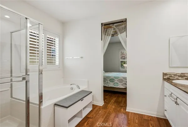 a bathroom with a tub sink and mirror