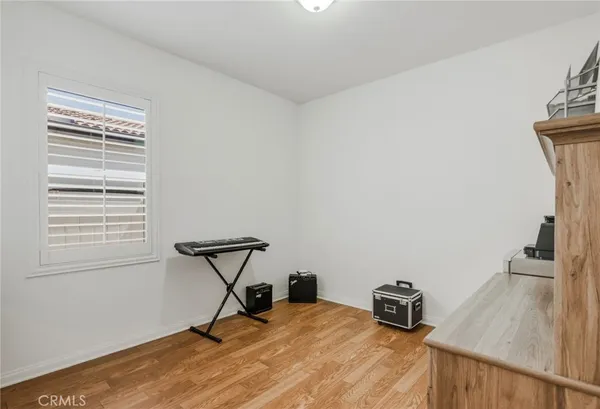 a view of a room with a window and wooden floor