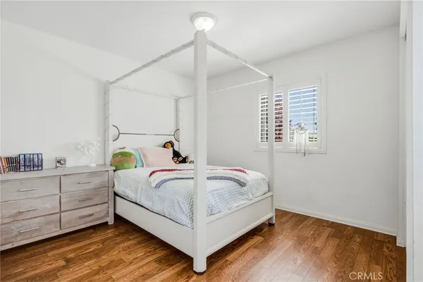 a bed sitting in a bedroom next to a window