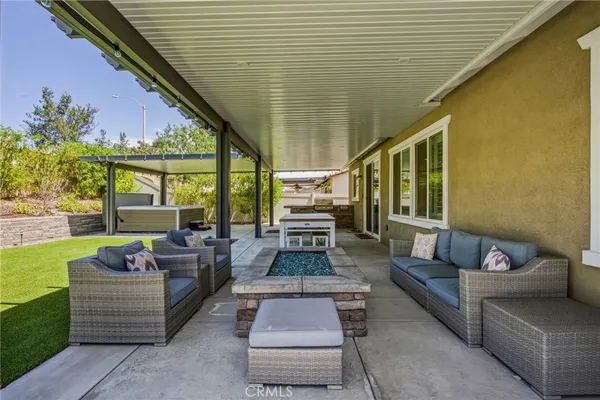 a backyard of a house with table and chairs