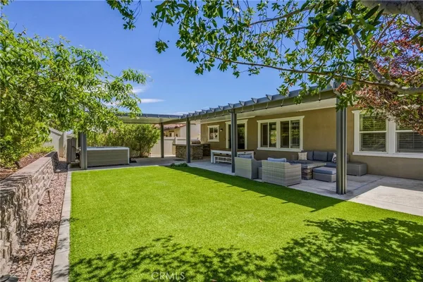 a view of a house with a backyard porch and sitting area