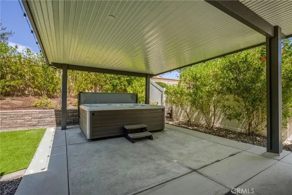 a view of a two chairs in the patio next to a yard