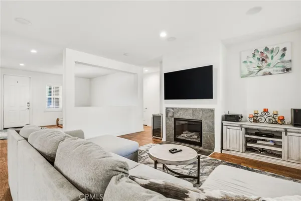 a living room with furniture a fireplace and a flat screen tv