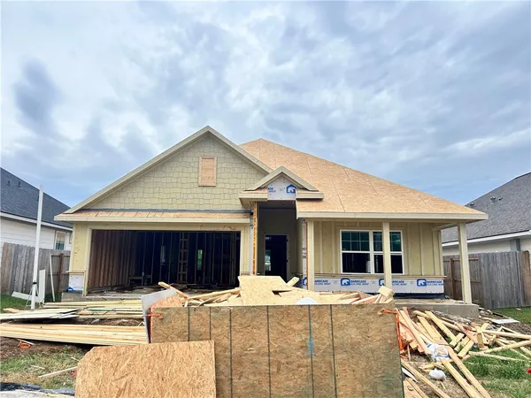 a view of a house with backyard and sitting area