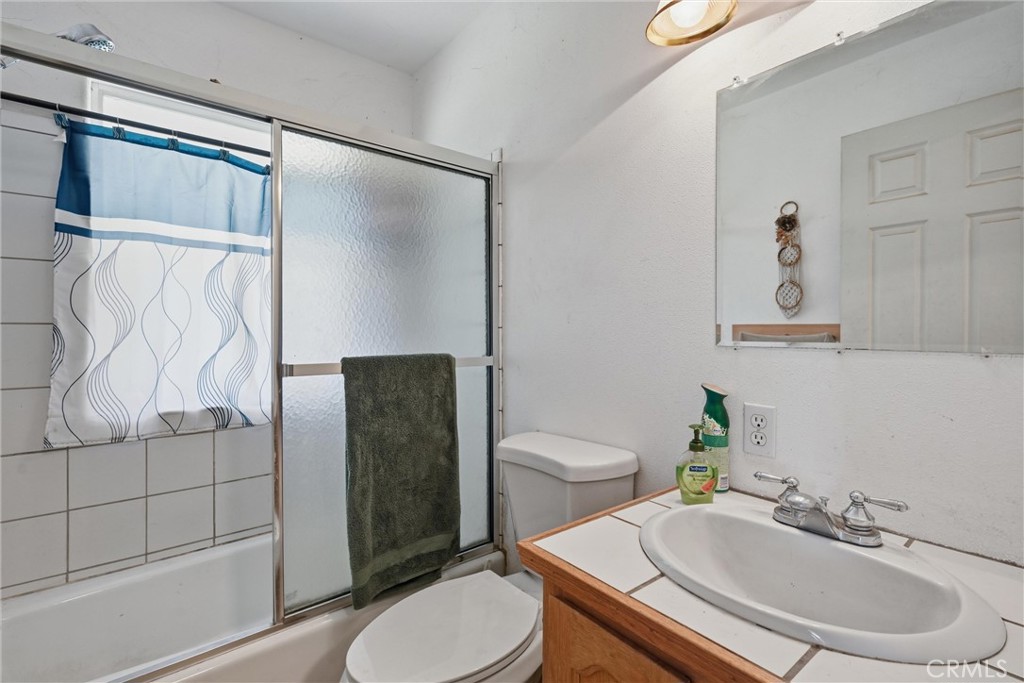 16965 Spruce Grove Road Hidden Valley Lake, CA 95467 - Photo 16 of 34 a bathroom with a sink toilet and shower