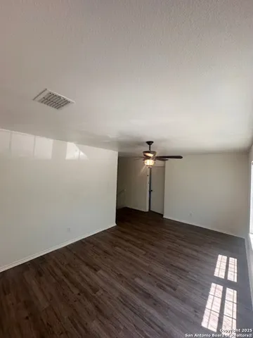 a view of a room with wooden floor