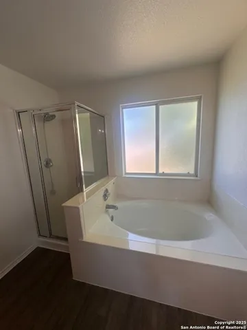 a bathroom with a bathtub and shower