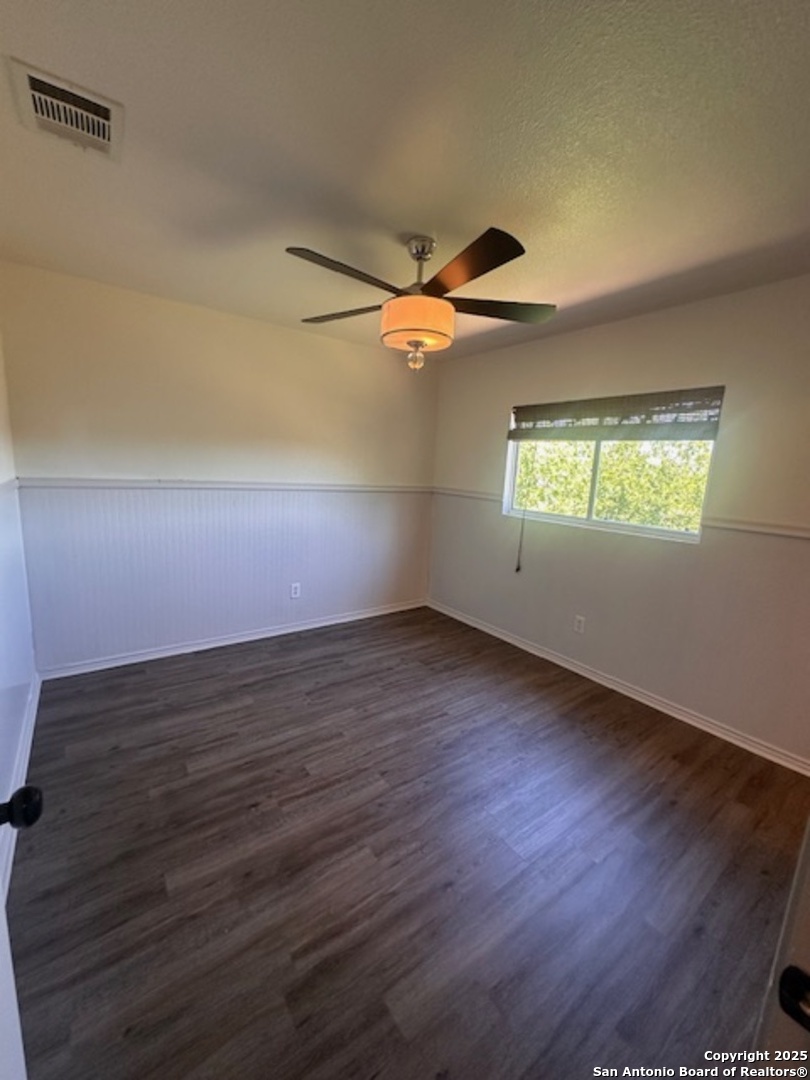 1667 Spice San Antonio, TX 78260 - Photo 23 of 25 a view of an empty room with wooden floor and a window
