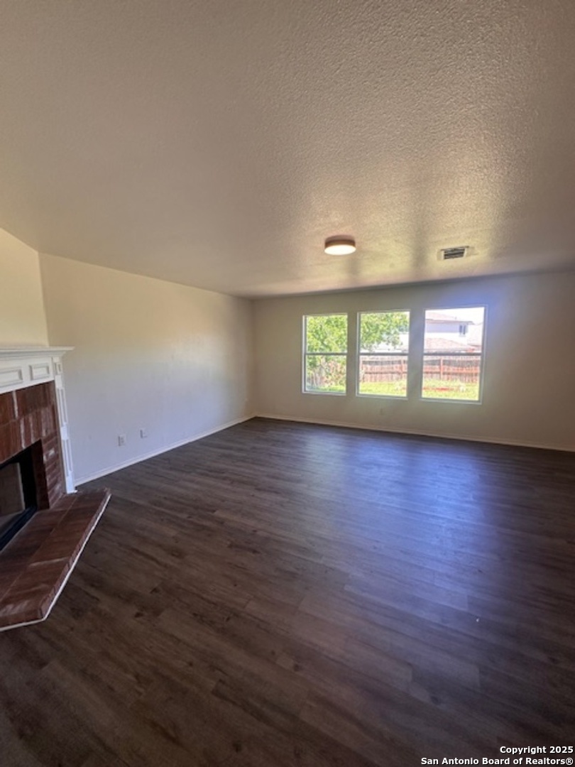 1667 Spice San Antonio, TX 78260 - Photo 4 of 25 a view of an empty room with wooden floor and a window