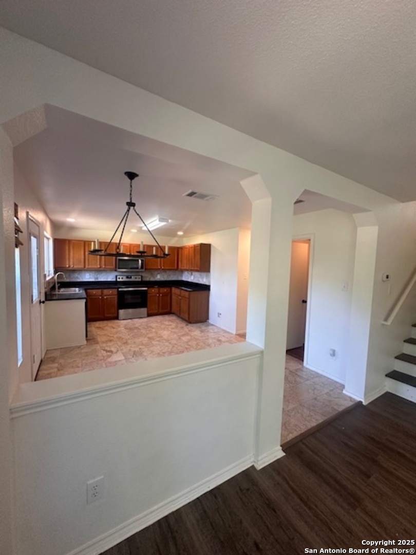 1667 Spice San Antonio, TX 78260 - Photo 7 of 25 a kitchen with kitchen island a sink and a stove