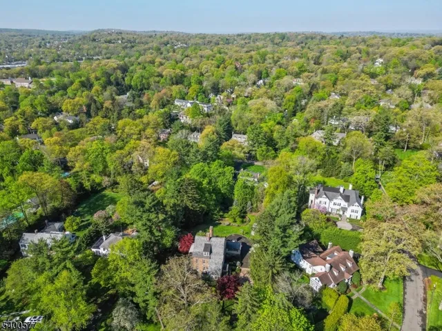 a view of a patio with couches and a fire pit and wooden fence