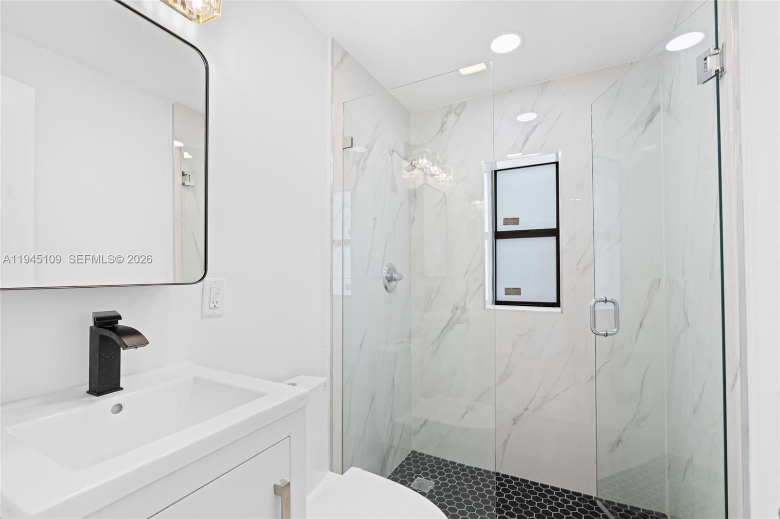 3030 Northwest 99th Street Miami, FL 33147 - Photo 12 of 27 a bathroom with a sink toilet and shower