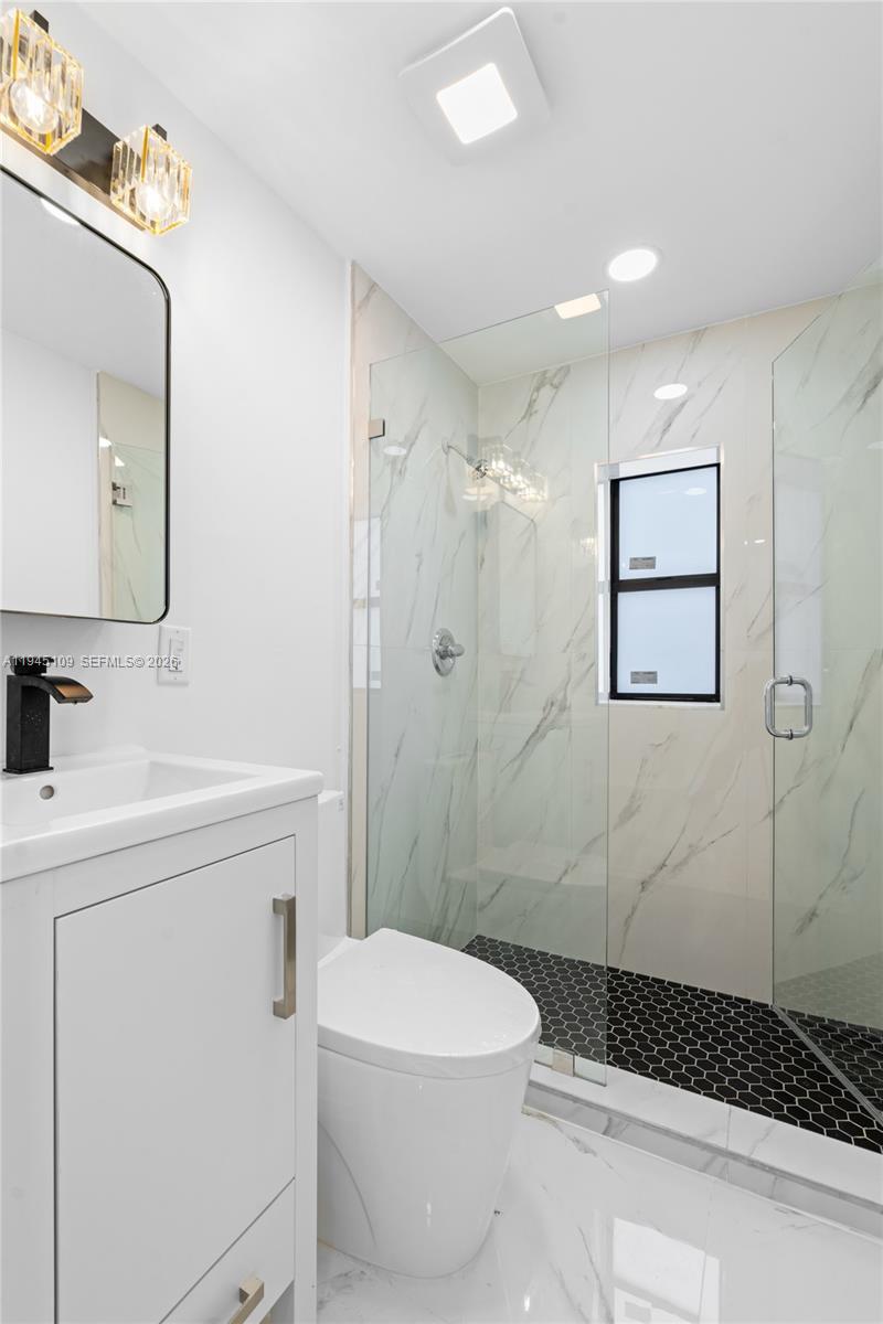 3030 Northwest 99th Street Miami, FL 33147 - Photo 13 of 27 a bathroom with a sink a toilet and shower