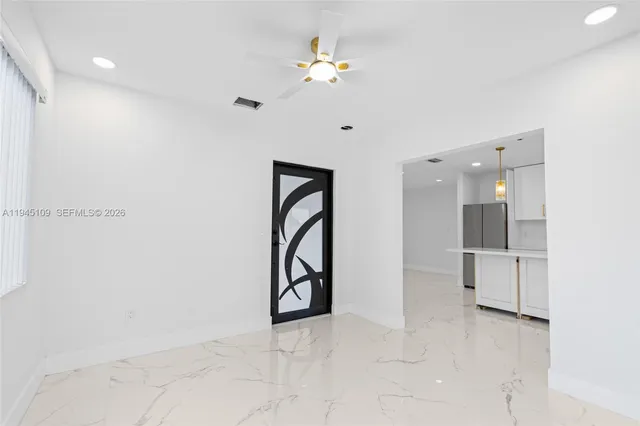 a view of an empty room with a fan