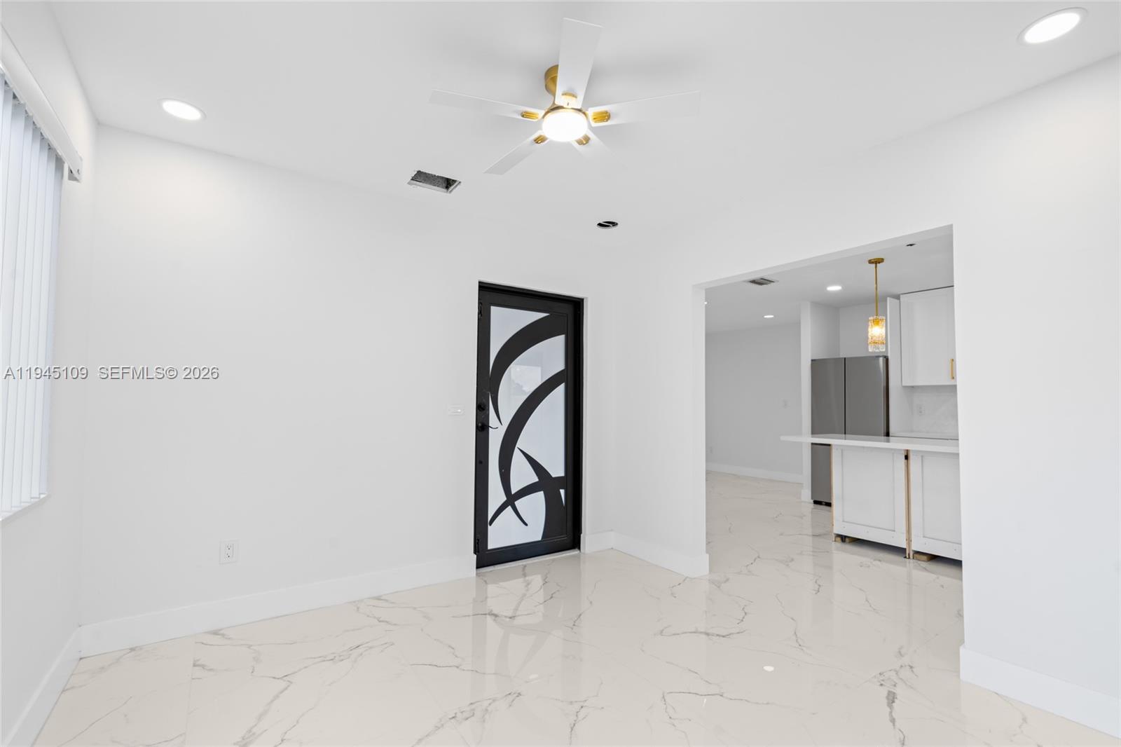 3030 Northwest 99th Street Miami, FL 33147 - Photo 14 of 27 a view of a hallway with a chandelier