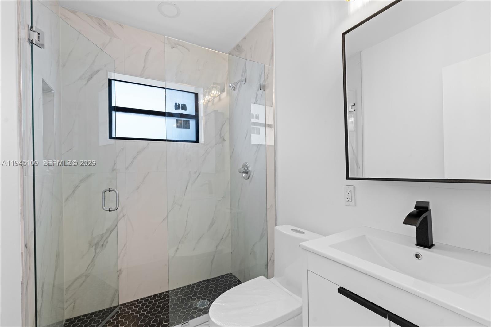 3030 Northwest 99th Street Miami, FL 33147 - Photo 17 of 27 a bathroom with a sink toilet and shower