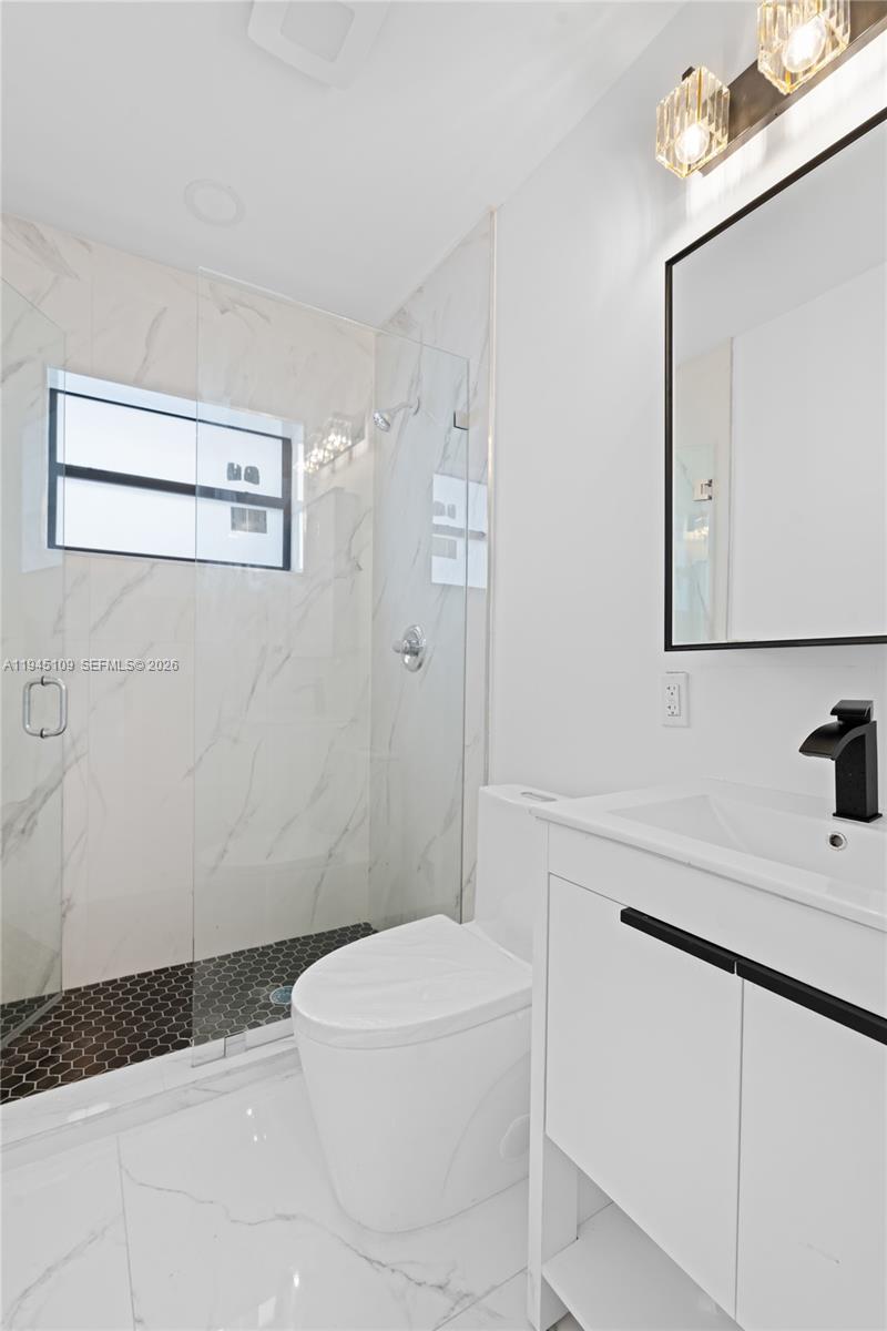 3030 Northwest 99th Street Miami, FL 33147 - Photo 18 of 27 a bathroom with a sink a toilet and shower