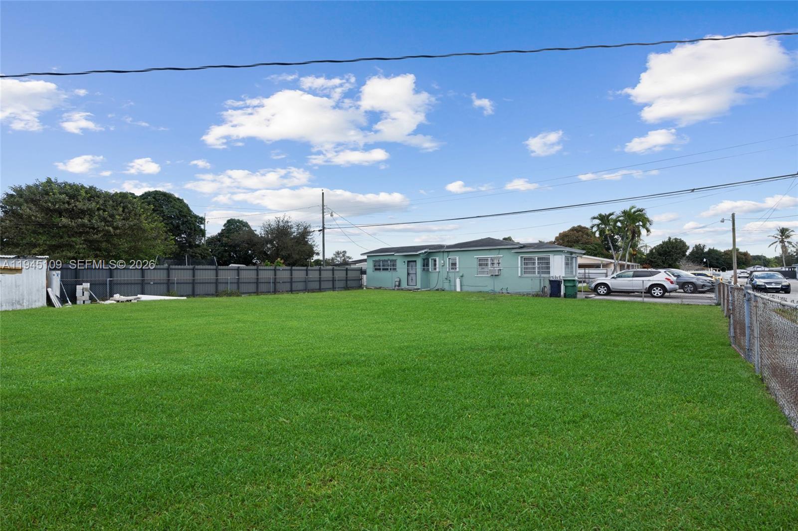 3030 Northwest 99th Street Miami, FL 33147 - Photo 22 of 27 a view of a house with a back yard
