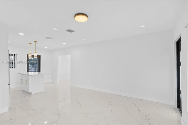 a kitchen with stainless steel appliances a refrigerator sink and stove