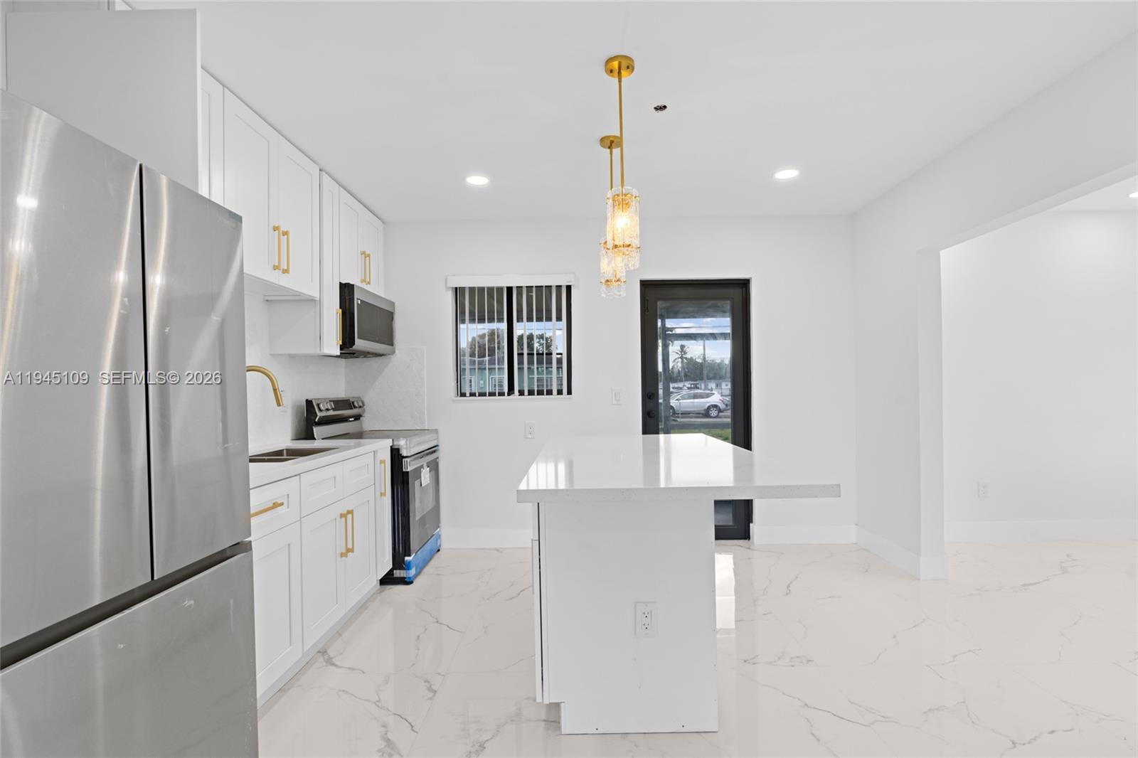 3030 Northwest 99th Street Miami, FL 33147 - Photo 9 of 27 a kitchen with stainless steel appliances a refrigerator sink and stove