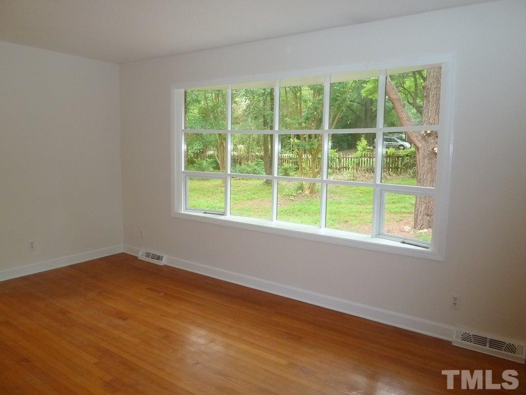 3808 Cole Mill Road Durham, NC 27712 - Photo 3 of 17 This sunny living room features a bowed window and original hardwood floors.