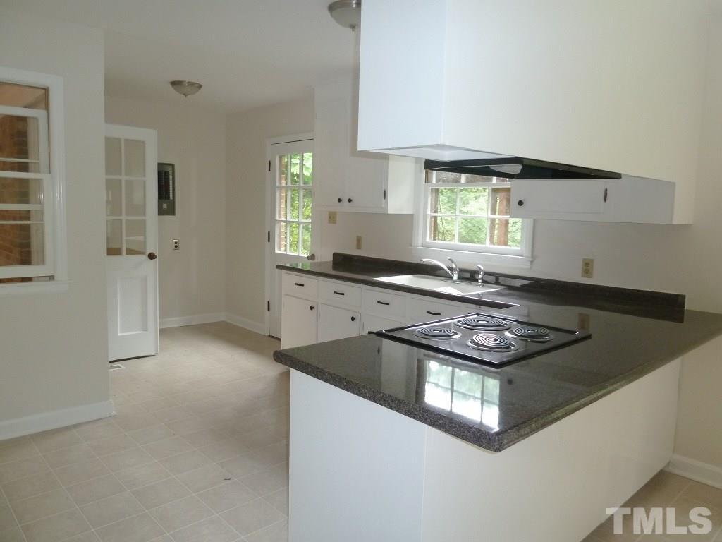 3808 Cole Mill Road Durham, NC 27712 - Photo 5 of 17 This view of the kitchen shows the door that leads to the sunken family room and the door that leads out to the large covered back deck.