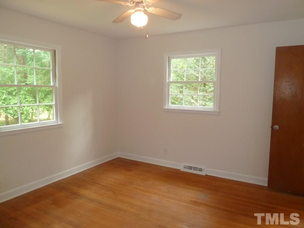 3808 Cole Mill Road Durham, NC 27712 - Photo 9 of 17 This master bedroom has hardwood floors and features a full bath.