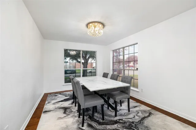 a view of a dining room with a table and chairs