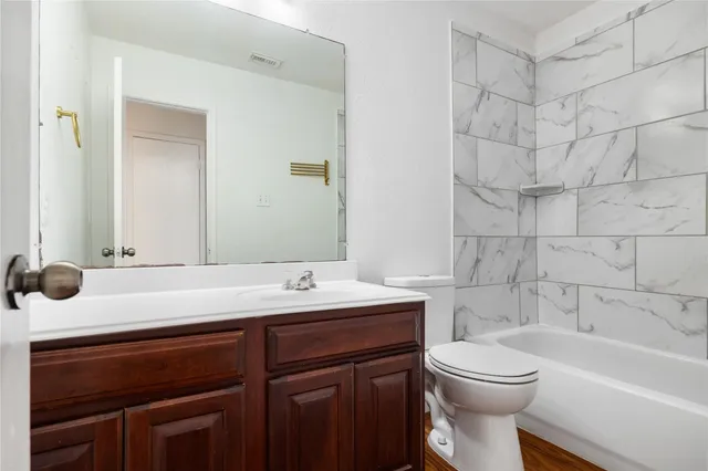 a bathroom with a sink a toilet and bathtub