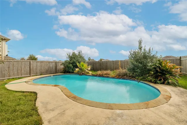 a view of a swimming pool with a yard