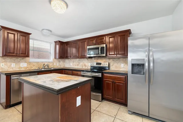 a kitchen with a sink stove and refrigerator